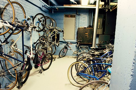 a room with many bikes hanging on the wall